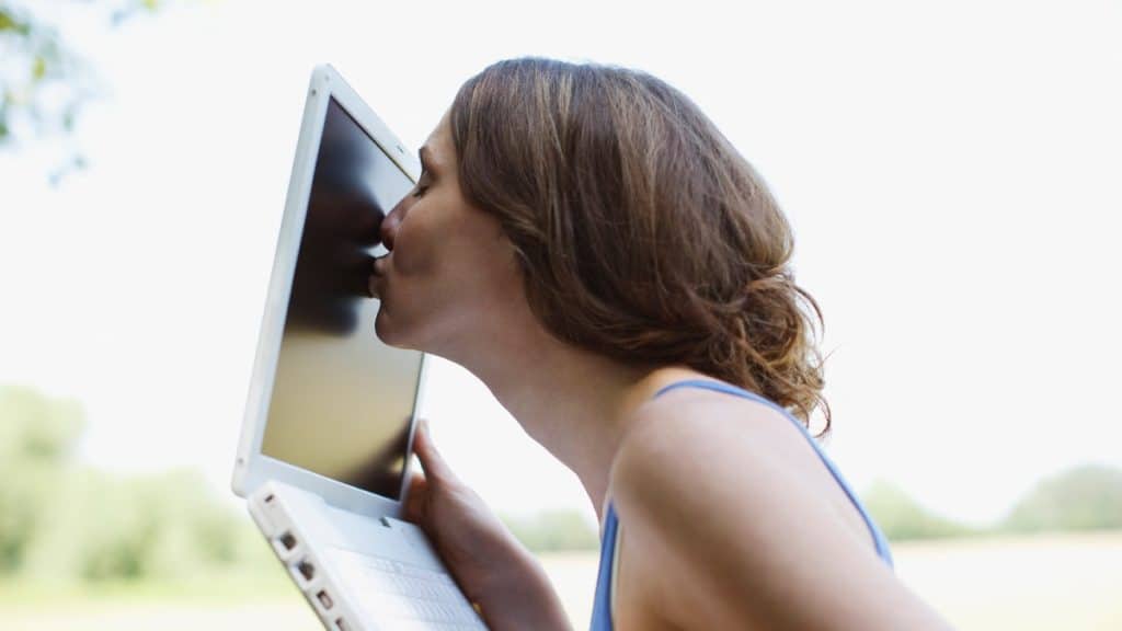 Lady kissing laptop