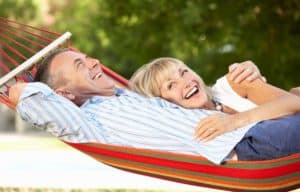 A senior couple relaxing together in a hammock