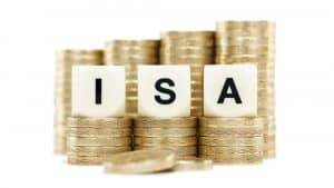 The letters ISA (Individual Savings Account) on dice on stacks of gold coins on a white background.