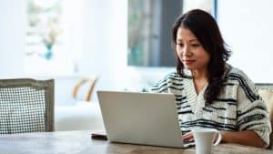 Woman using laptop and working from home
