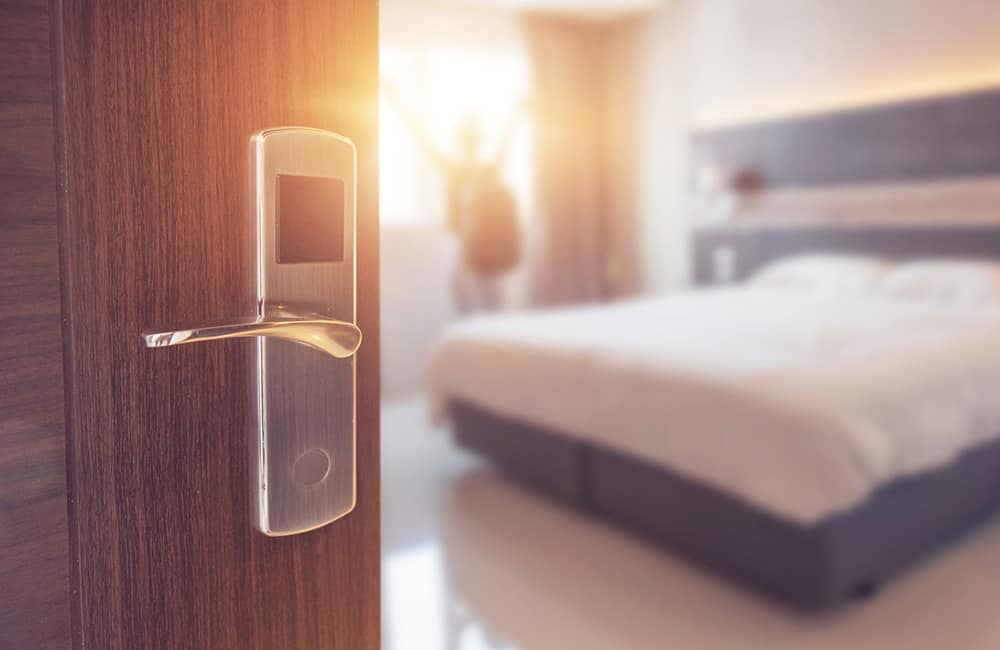 An open door reveals the interior of a luxury hotel room