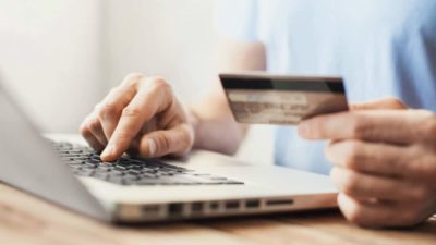 Young man shopping with credit card and laptop computer