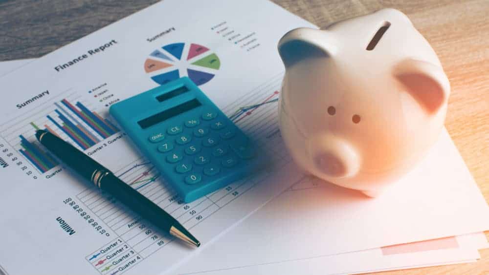 Piggy bank next to a financial report