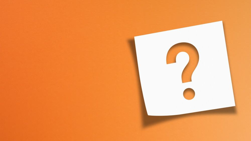 Note paper with question mark on orange background
