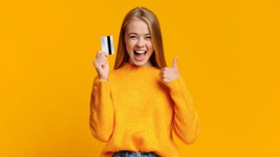 Girl showing thumb up, excited about upcoming shopping