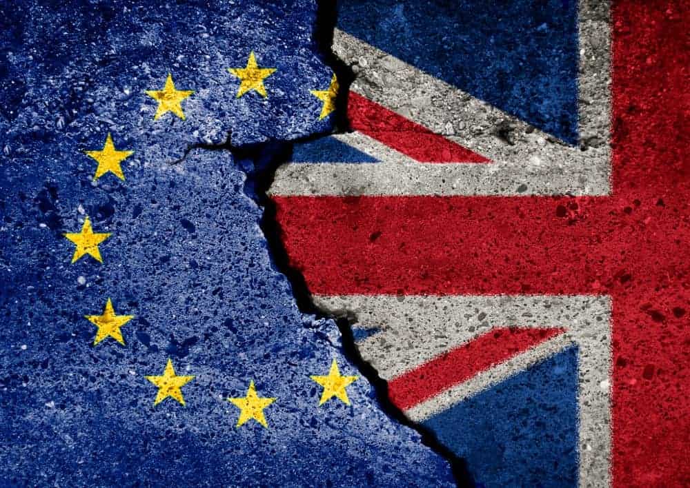 EU and UK flag on broken wall