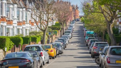 Typical street lined with terraced houses and parked cars