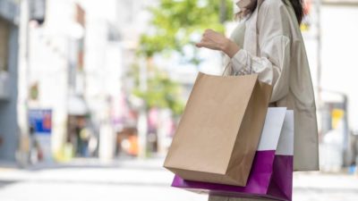 Hands of woman with many shopping bags