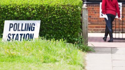 Polling Stations, as depicted with a woman taking her polling card to cast her vote