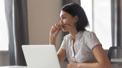 Thoughtful anxious asian business woman looking away thinking solving problem