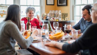 Two-generation multi-religious family celebrating both Christmas and Hanukkah together