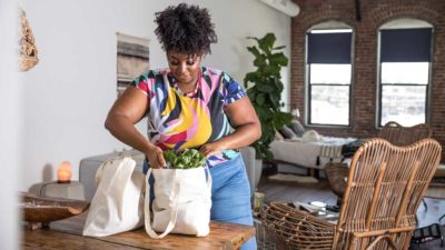 Woman back at home after shopping groceries