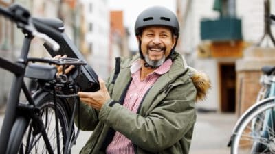 Man changing battery on electric bicycle