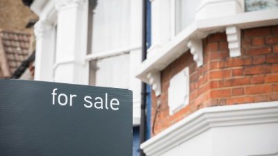 For Sale signs displayed outside terraced houses