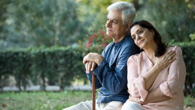 Thoughtful senior couple relaxing at park