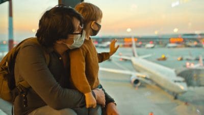 Family in protective face masks in airport