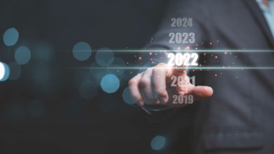 Businessman touching on number 2022 for preparation