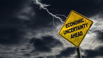 Economic Uncertainty Ahead Sign With Stormy Background