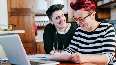 Couple paying bills online at home