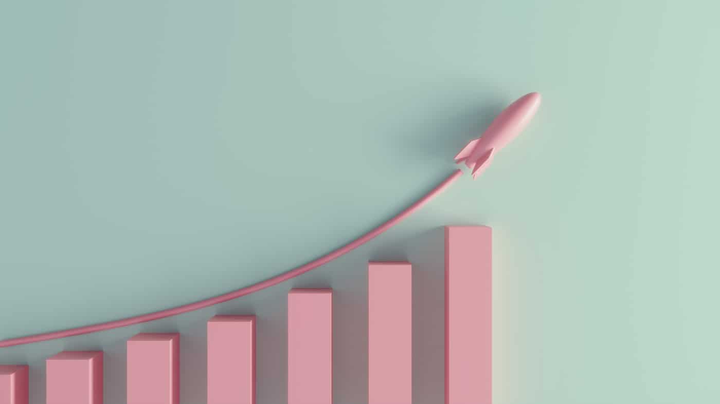 A pastel colored growing graph with rising rocket.