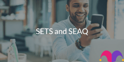 Man looking at a mobile phone with the text "SETS and SEAQ" and the Motley Fool Logo