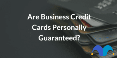 Stack of credit cards with text “Are business credit cards personally guaranteed” and The Motley Fool jester cap logo