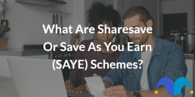 Couple doing online research with the text “What are sharesave or save as you earn (SAYE) schemes?” and The Motley Fool jester cap logo