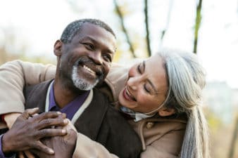 Storytelling image of a multiethnic senior couple in love - Elderly married couple dating outdoors, love emotions and feelings
