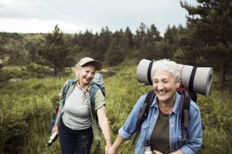 Close up of two senior females hiking together
