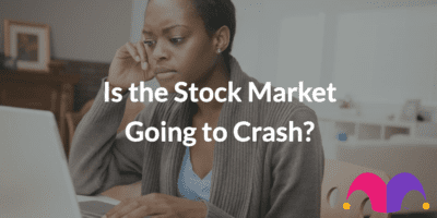A woman looking at her computer concerned with the text "Is the Stock Market Going to Crash?"