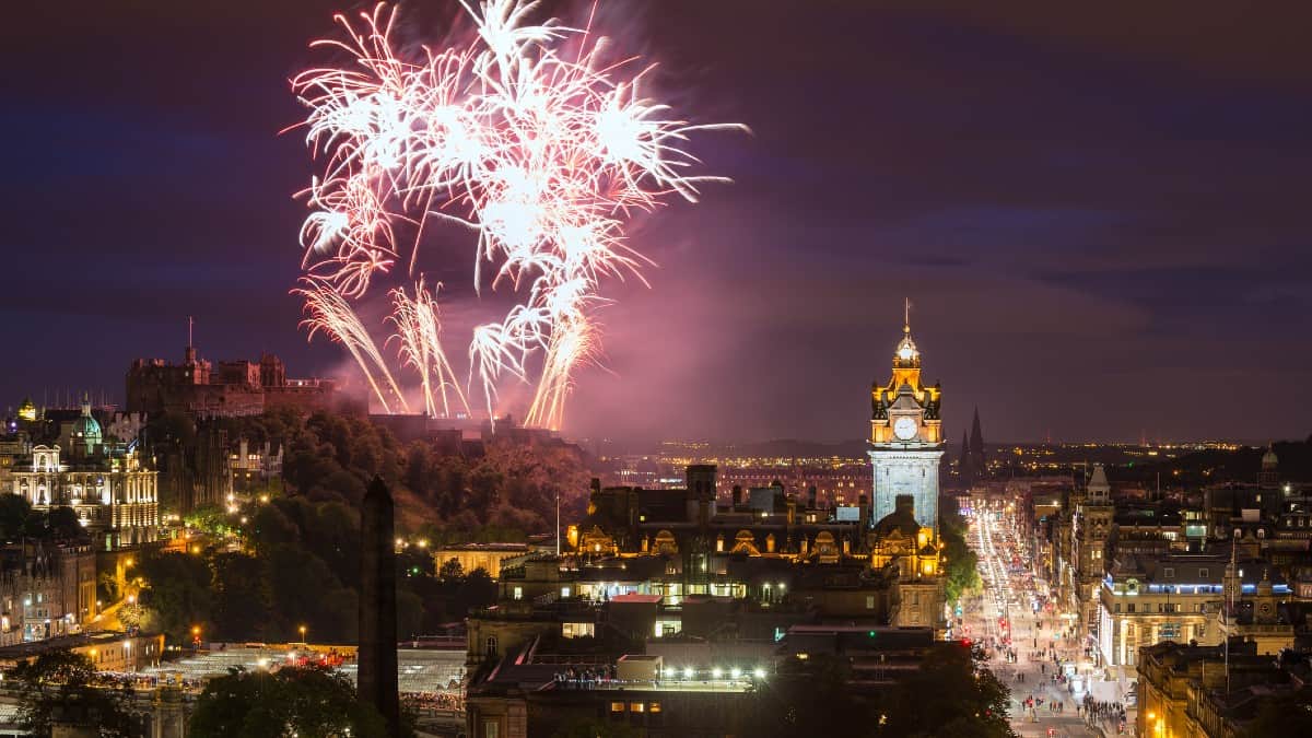 Edinburgh Cityscape with fireworks over The Castle and Balmoral Clock Tower