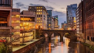 Modern apartments on both side of river Irwell passing through Manchester city centre, UK.