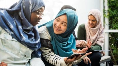 Diverse group of students using mobile phone