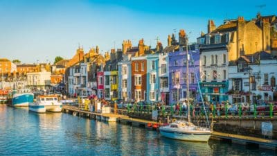 Warm summer evening outside waterfront pubs and restaurants at the popular seaside resort town of Weymouth, Dorset.