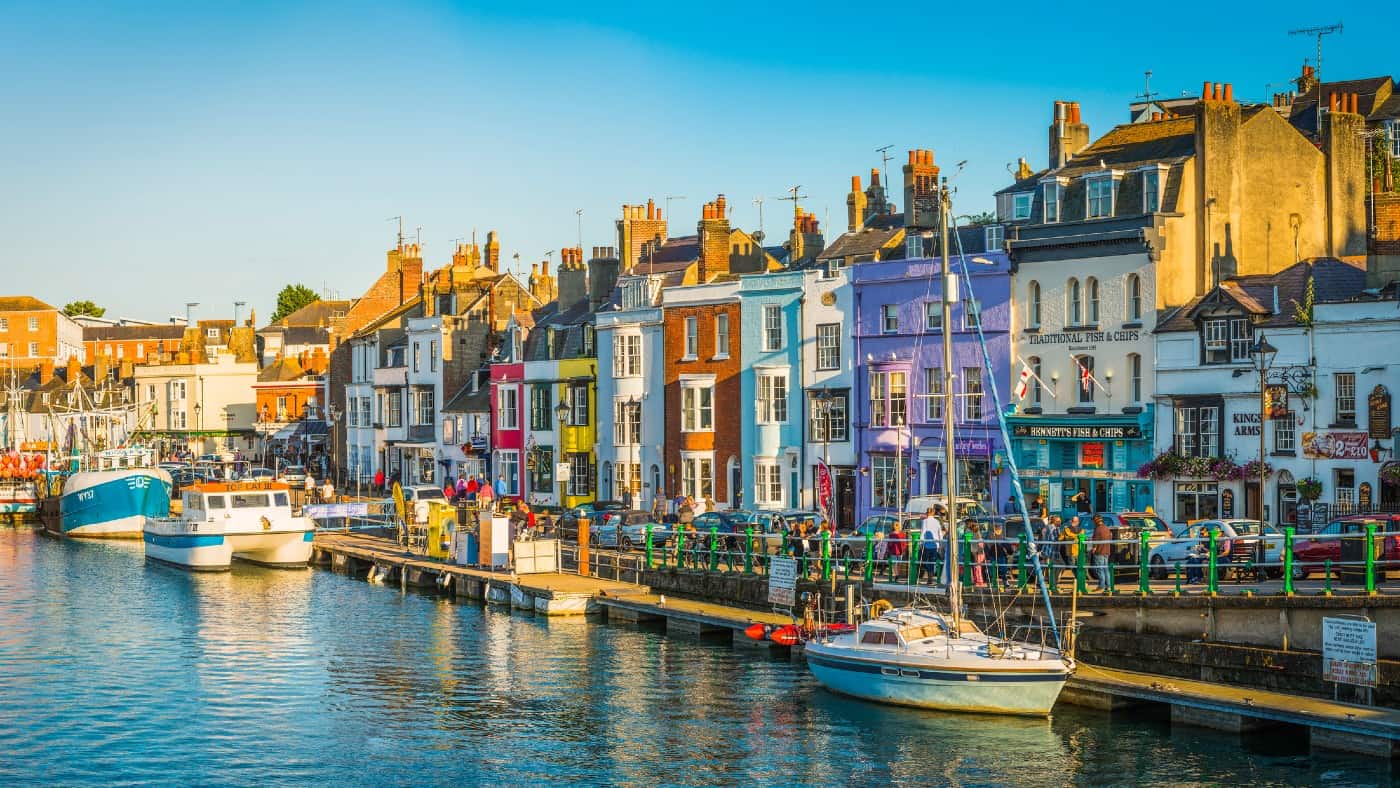 Warm summer evening outside waterfront pubs and restaurants at the popular seaside resort town of Weymouth, Dorset.