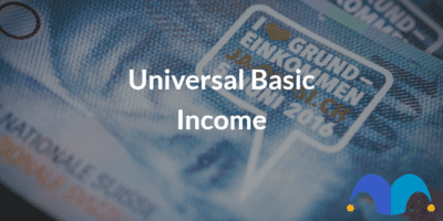 Money with the text “Universal Basic Income” and The Motley Fool jester cap logo