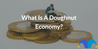 Man sitting on coins with the text “What is a doughnut economy?” and The Motley Fool jester cap logo