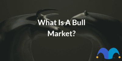 Bronze Bull and Bear faceing off with the text “what is a bull market?” and The Motley Fool jester cap logo