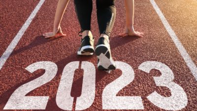 Athlete preparing to run on start line in a lane numbered '2023'