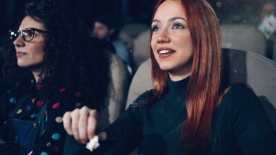 Close up of a group of friends enjoying a movie in the cinema