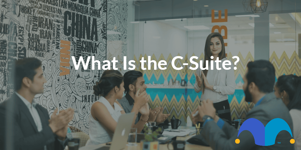 Group of corporate execs with the text “What Is the C-Suite?” and The Motley Fool jester cap logo