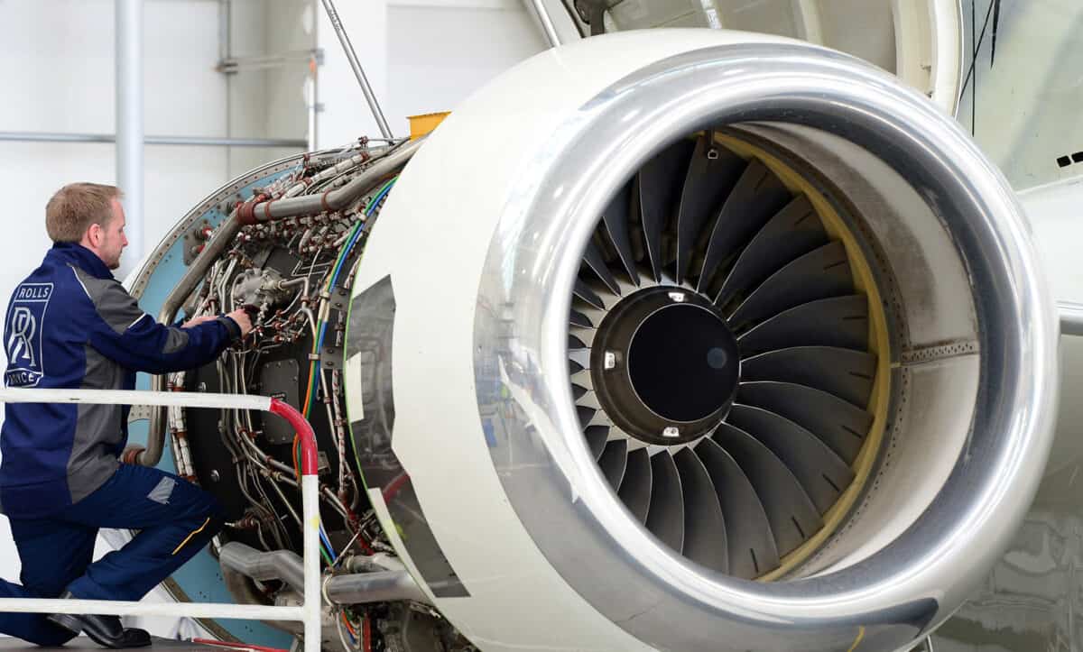 Engineer working on a Rolls-Royce aircraft engine.