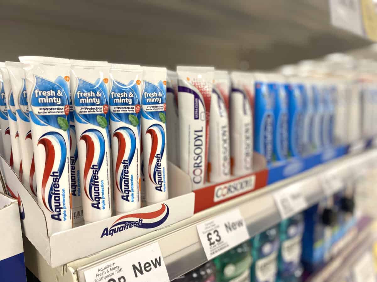 Toothpaste tubes on a shelf.